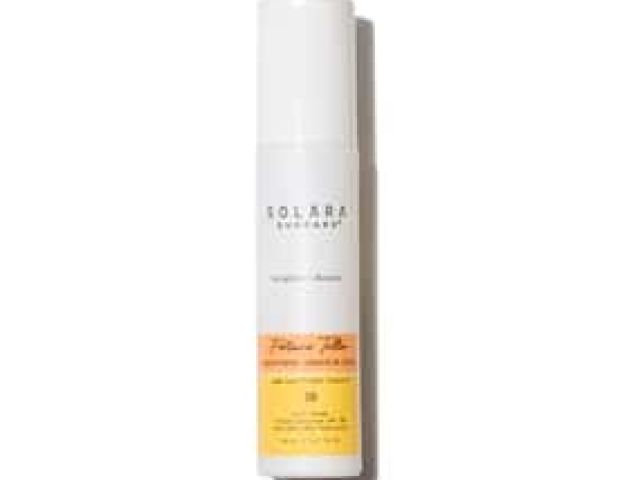 Photograph: white pump sunscreen bottle with yellow label, shadow on white background