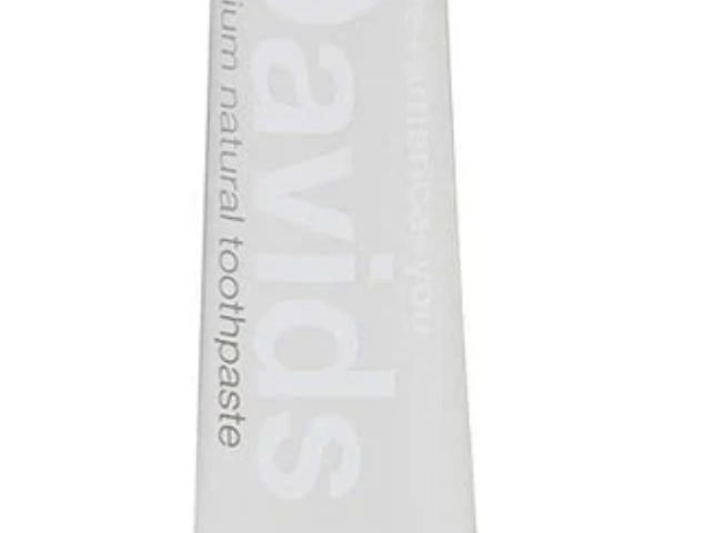 Photograph of white Davids toothpaste tube labeled charcoal with black cap