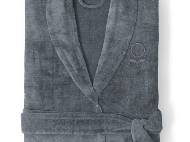 Photograph: folded dark gray plush bathrobe with shawl collar and tied belt, embroidered logo.