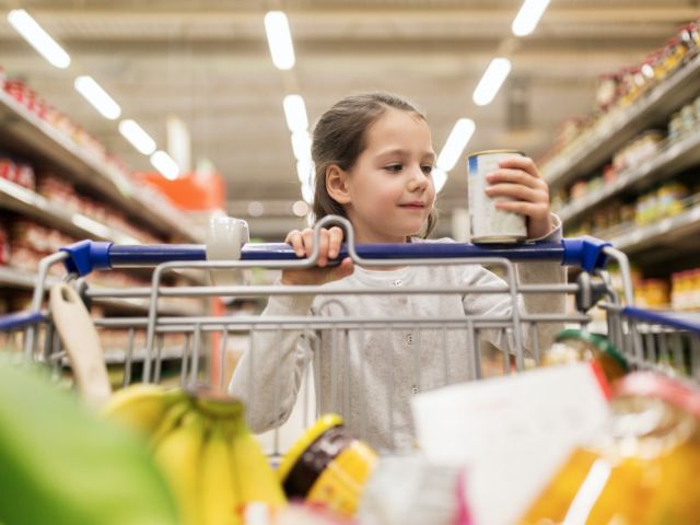 Child looking at canned foods
