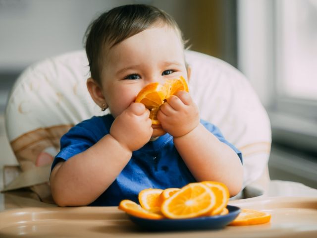 Child eating an orange
