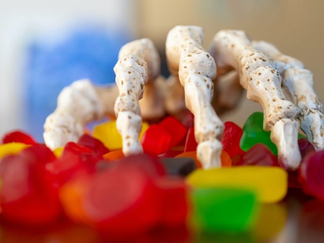Skeleton hand reaching for candy