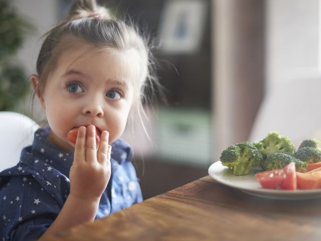 Child eating brocolli