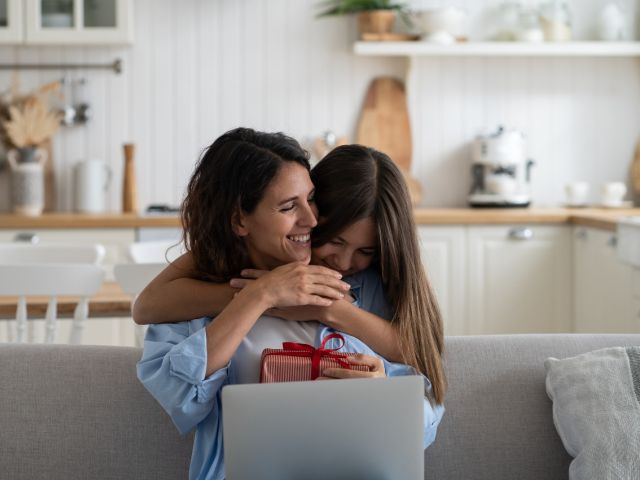 Daughter giving mother holiday gift