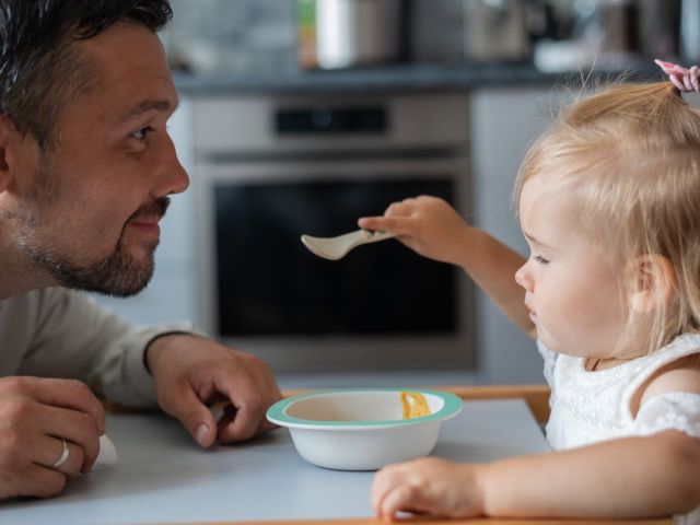 Father and daughter eating together