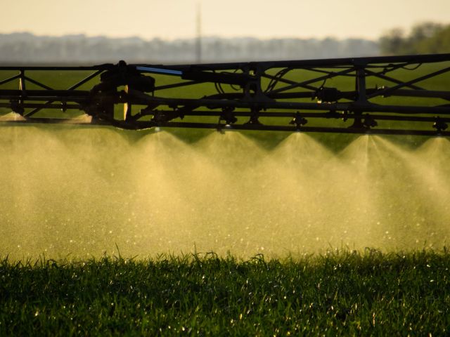 Fertilizer being sprayed on a crop.