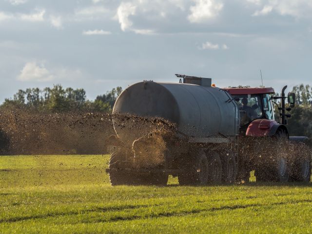 Manure being sprayed on a farm field.