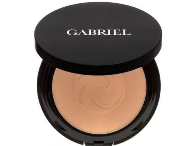 Compact makeup with the label "GABRIEL," revealing a soft beige powder inside.