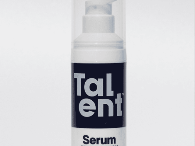 White serum bottle with a pump, labeled "Talent Serum Triple Action" for all skin types.