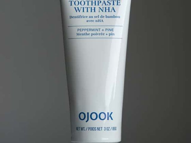 White toothpaste tube labeled "Bamboo Salt Toothpaste with NHA" in a minimalist design.
