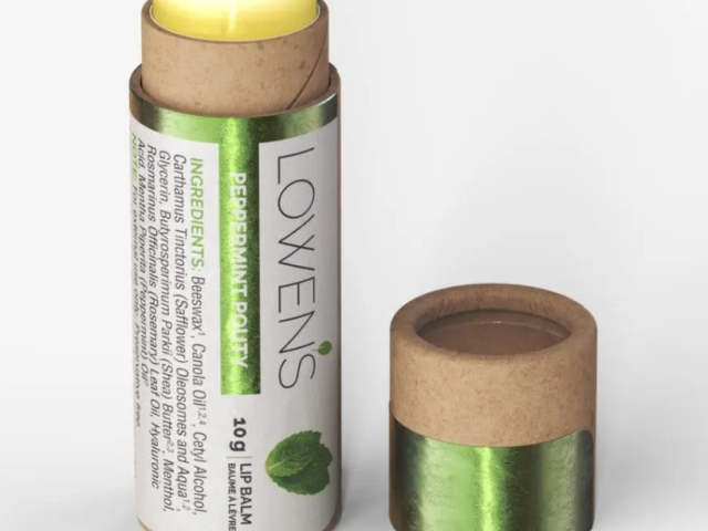 Eco-friendly lip balm tube with yellow cap and green label, partially opened.