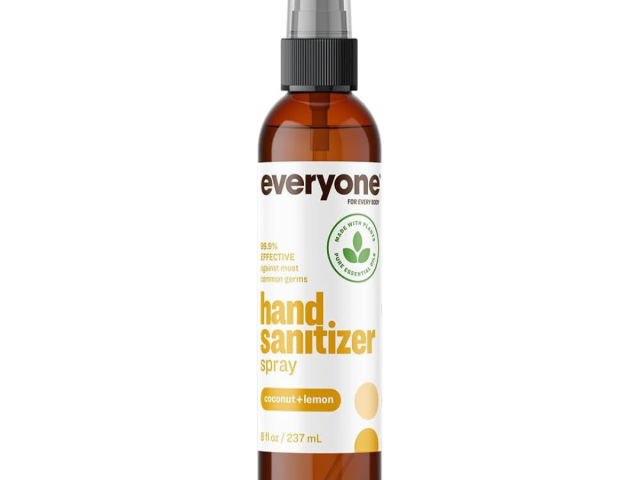 Brown spray bottle of hand sanitizer with coconut and lemon scent.