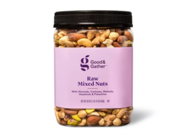 A clear jar filled with raw mixed nuts, labeled "Good & Gather" in pink.