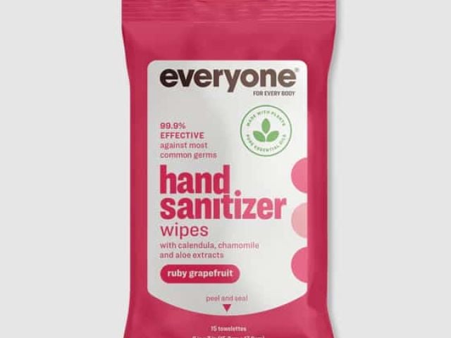 Pink packaging for hand sanitizer wipes featuring "ruby grapefruit" scent and botanical extracts.