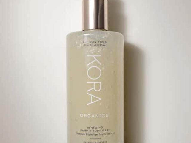 Transparent bottle of KORA Organics Renewing Hand & Body Wash with a pump dispenser.