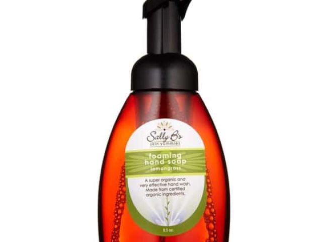 Foaming hand soap in an orange pump bottle with a green label.