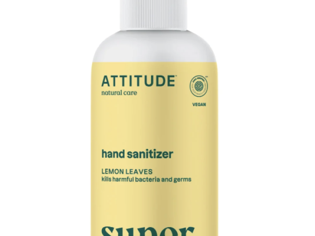 A spray bottle of hand sanitizer labeled "ATTITUDE" with lemon leaves design.