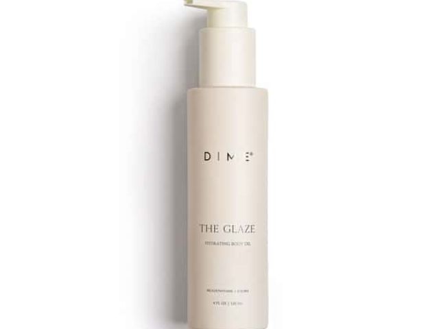 Light beige bottle of body oil with a pump, labeled "THE GLAZE" by DIME.