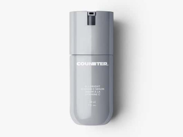 Gray cosmetic bottle with a pump top, labeled "COUNTER."