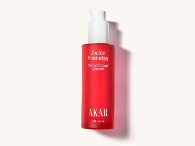 Red moisturizer bottle with a pump top, labeled "Soothe Moisturizer" and "AKAR."