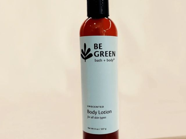 Unscented body lotion bottle with a white label on a beige background.