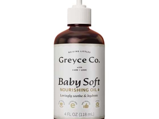 Brown glass bottle of Baby Soft nourishing oil with a pump top and labeled content.