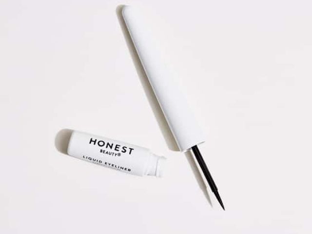Black liquid eyeliner with a white cap and a small tube labeled "Honest Beauty."