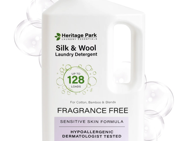 Plastic bottle of Heritage Park Silk & Wool laundry detergent with bubbles in background.