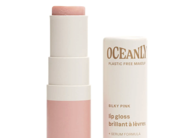 Pink lip gloss tube next to its case, featuring a sleek, minimalist design.