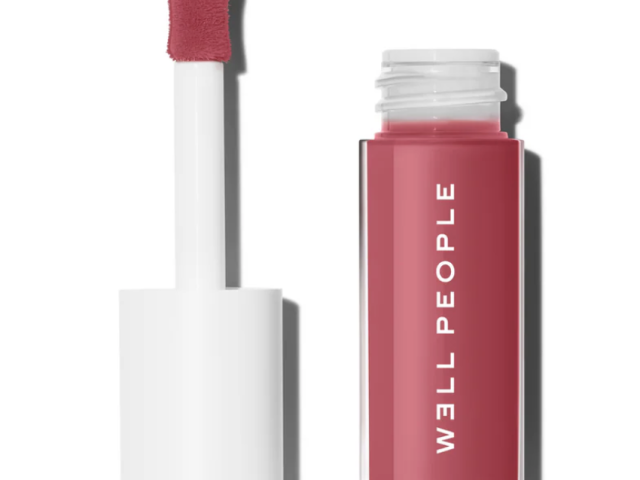 A tube of pink lip color with a doe-foot applicator next to it.