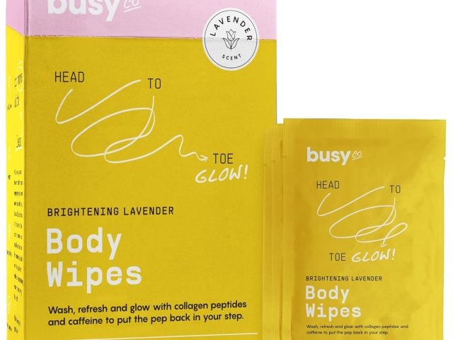 Photograph: Busy Co. Brightening Lavender body wipes box and two sachets, yellow and pink.