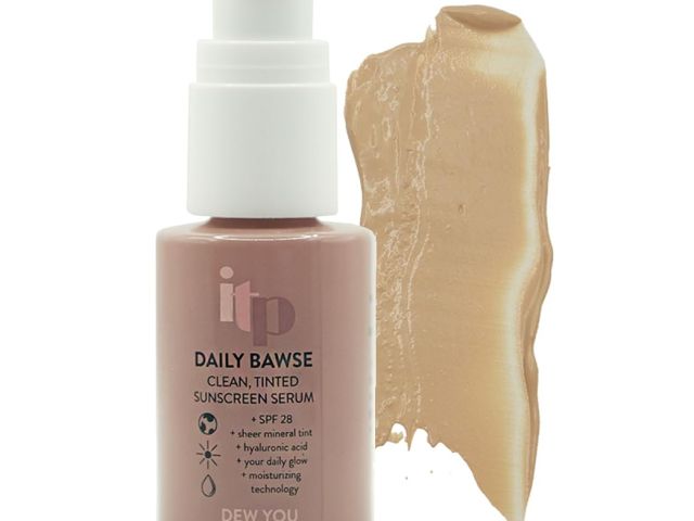Photograph of a pump bottle of tinted sunscreen serum with a beige swatch