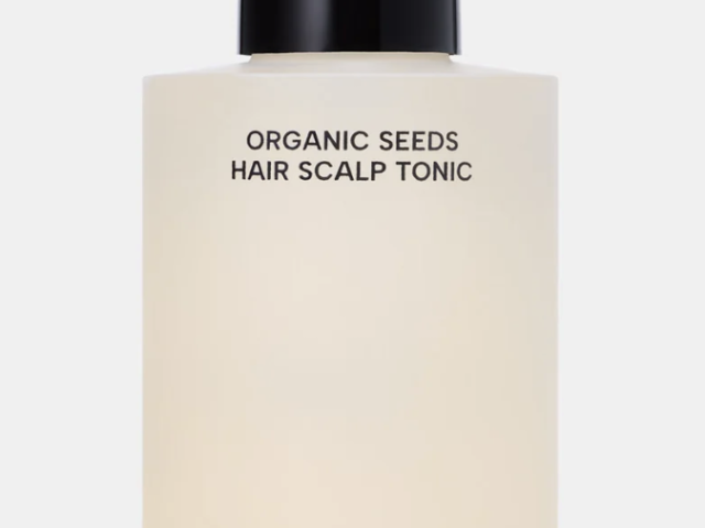 Product photo — frosted pale bottle with black pump labeled Organic Seeds Hair Scalp Tonic