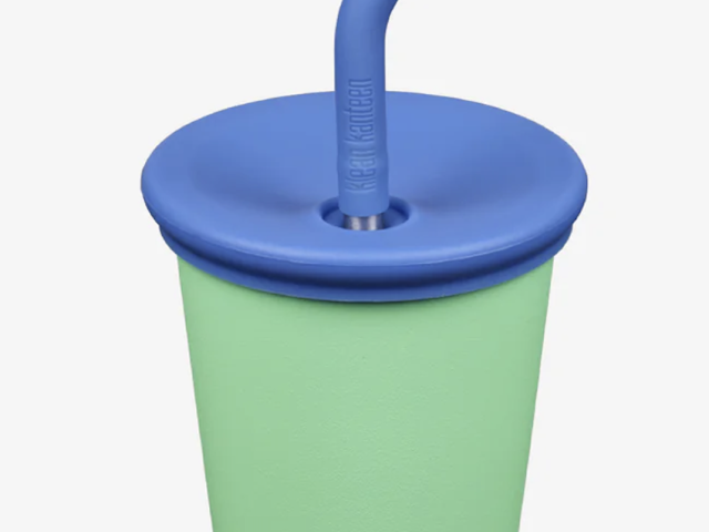 Photograph of mint-green Klean Kanteen cup with blue lid, bent straw and visible logo