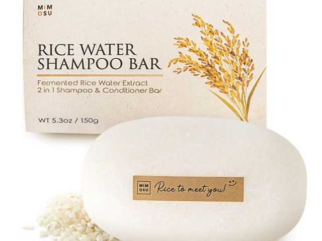 Photograph: white rice water shampoo bar, box with rice illustration and scattered rice grains