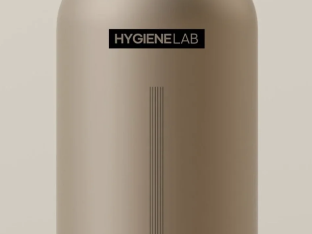 Photograph of beige shampoo bottle with black pump labeled HYGIENELAB