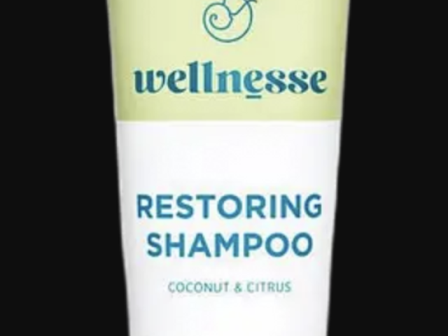 Photograph of Wellnesse Restoring Shampoo tube, coconut &amp; citrus, pale green and white