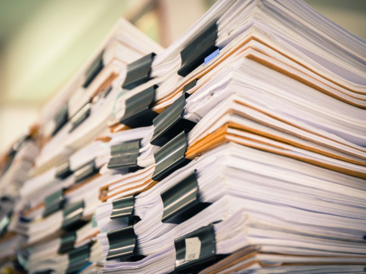 Pile upon pile of documents from a file cabinet