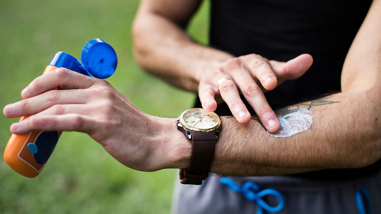 Person applying sunscreen