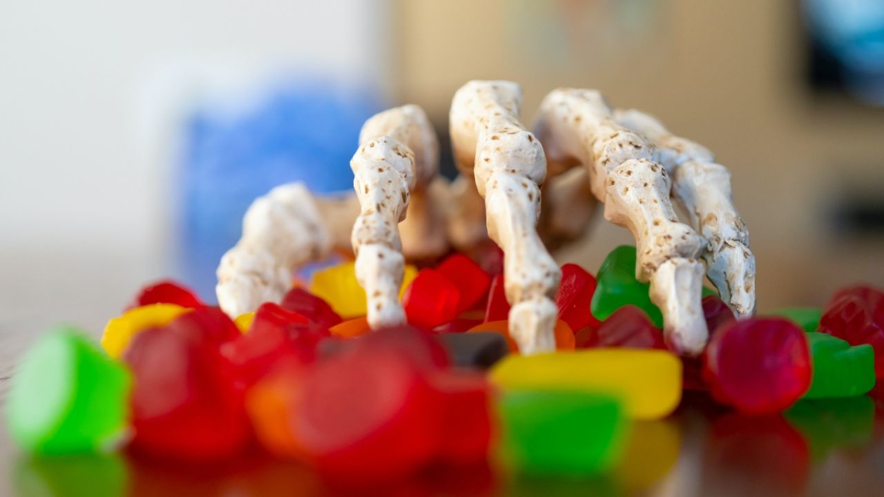 Skeleton hand reaching for candy