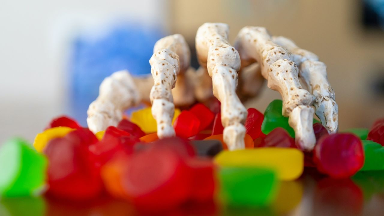 Skeleton hand reaching for candy