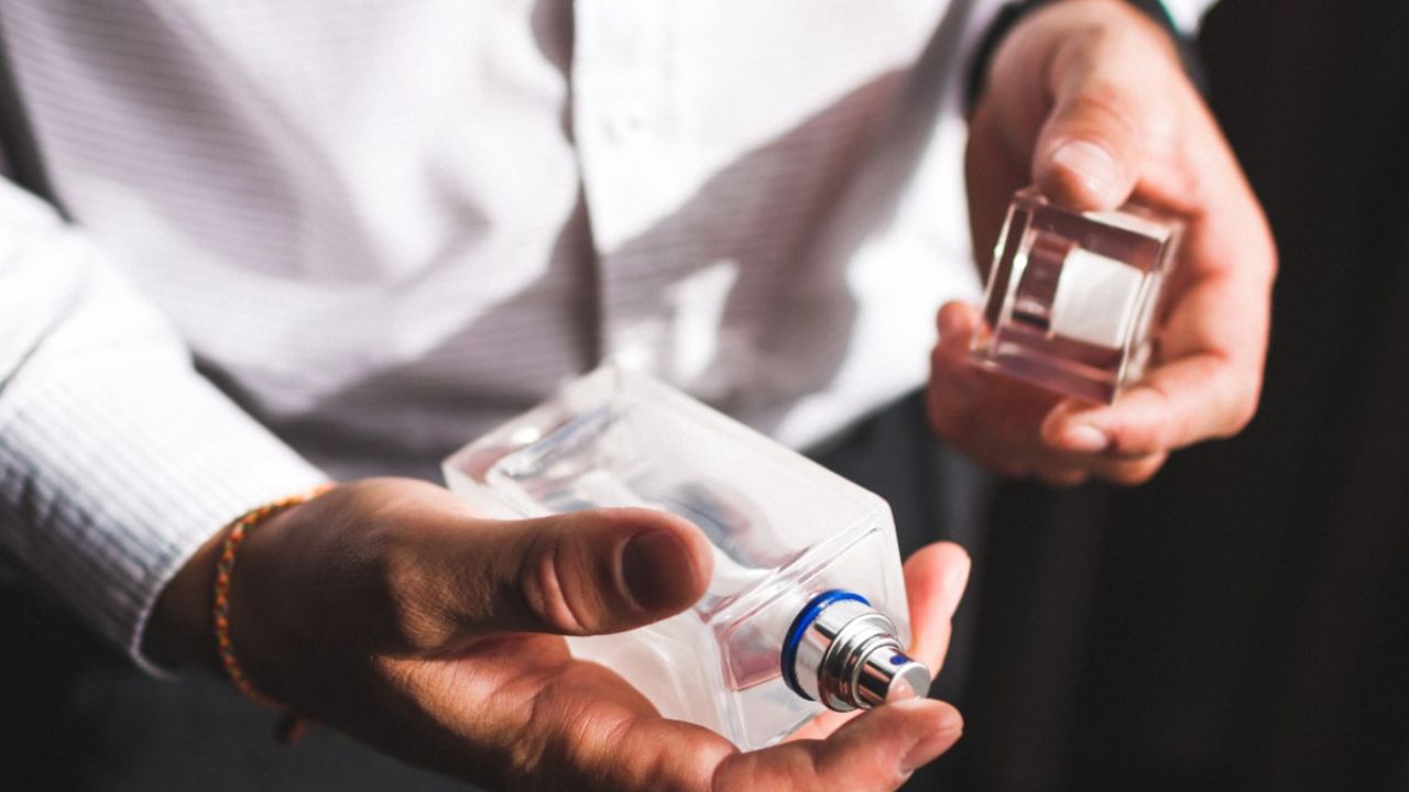 Person holding a fragrance bottle
