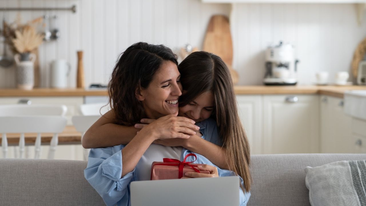 Daughter giving mother holiday gift