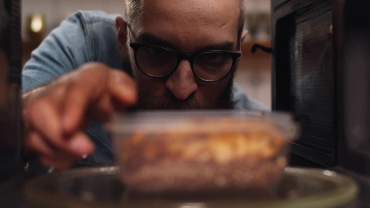 Person microwaving leftovers