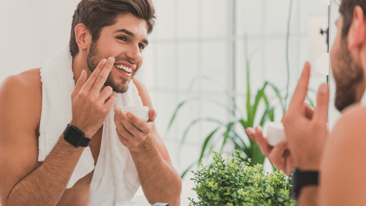 Man adding lotion to beard