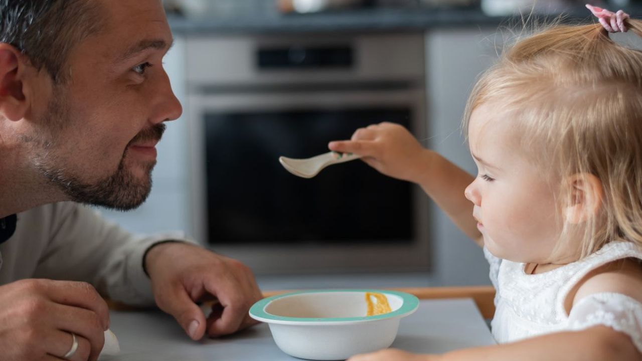 Father and daughter eating together
