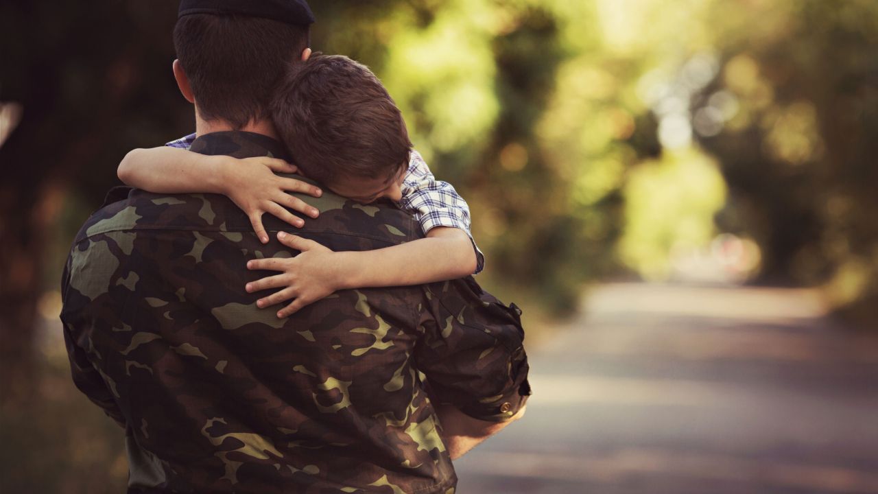 Solider hugging child