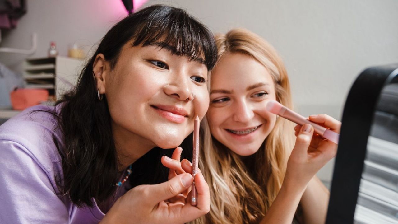 Two teens applying makeup